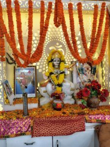 Decorated idol of Saraswati with marigold flowers during Vivekananda Jayanti celebration arranged by a yoga institute near Lake Gardens.