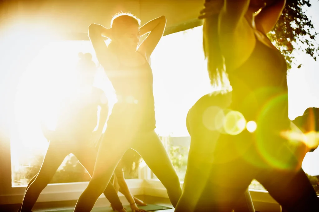 A group of females are doing yoga for summer heat.