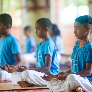 A group of children are practicing yoga and meditation together which is the Yoga for kids in Tollygunge