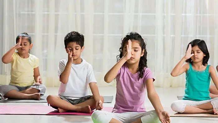 A group of children are performing the best yoga for kids in Tollygunge
