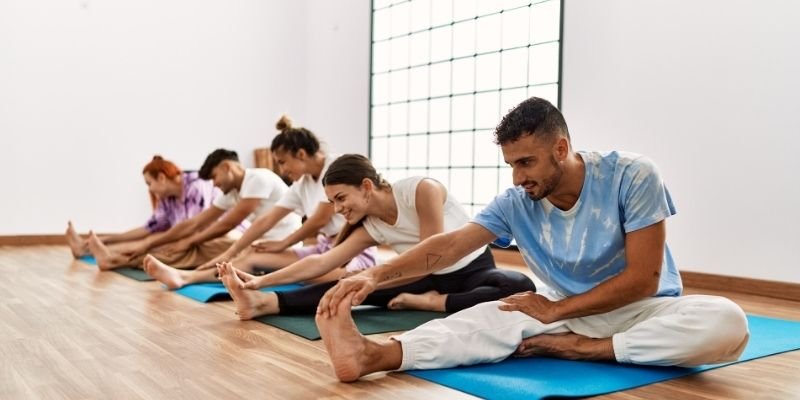 A group of people are practicing yoga at a Yoga Instructor Course near Kolkata
