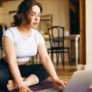 a lady is starting her first Online Yoga Classes in Kolkata and she is looking at the laptop